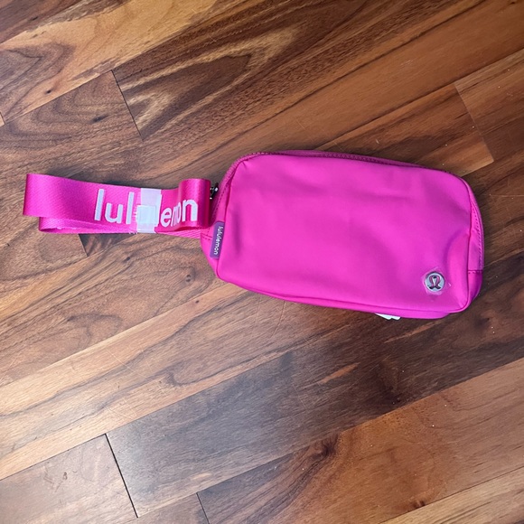 lululemon athletica Handbags - Lululemon Sonic Pink Belt Bag white Lulu wordmark on strap, NEW